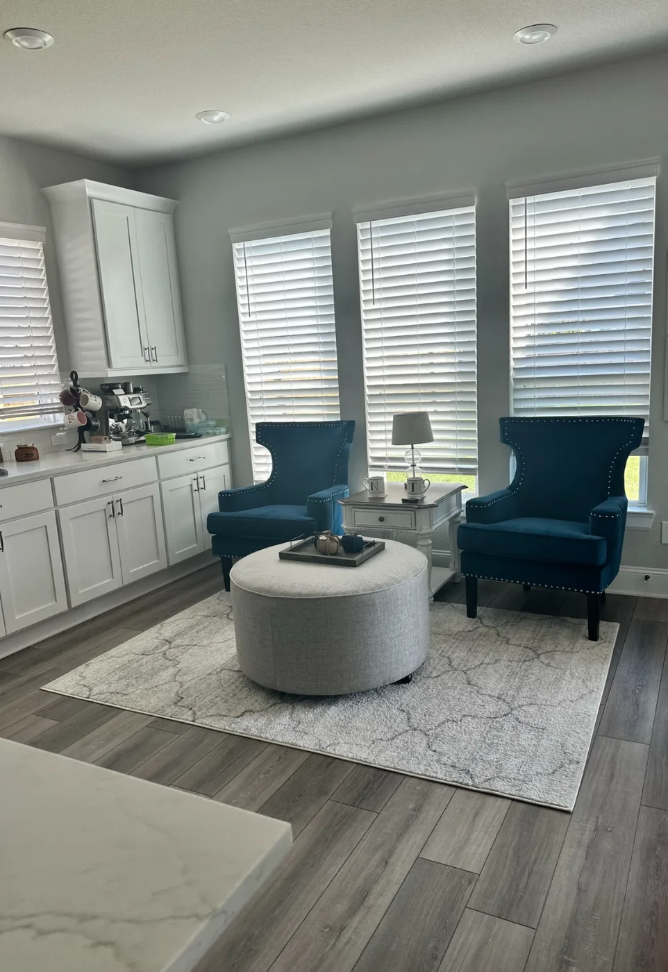 Sitting area by the kitchen with dusted furniture and clean floors